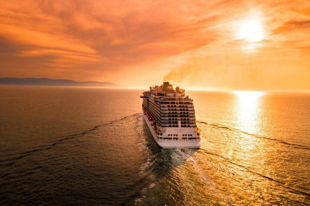 A Best cruise lines, grand cruise ship sailing at sunset with a scenic ocean view, symbolizing luxury travel and adventure.