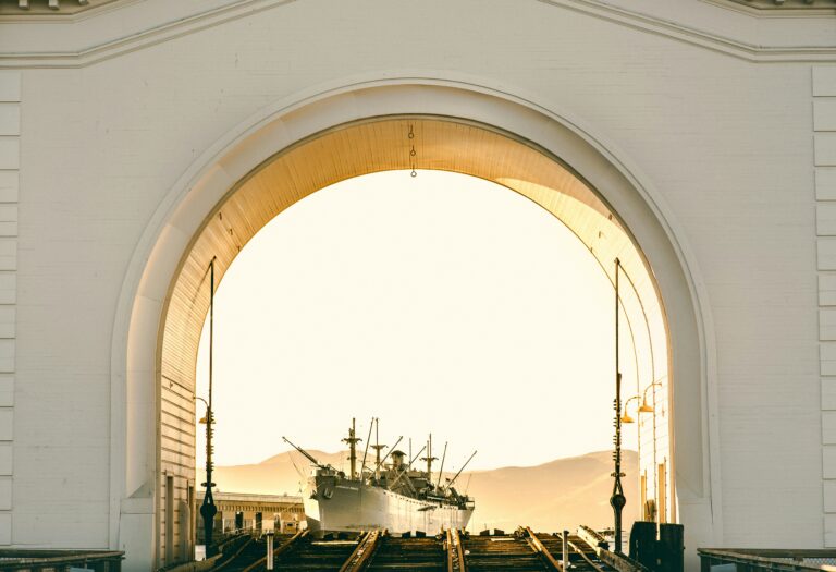 View of a cruise ship framed by a large archway, symbolizing departure from Galveston port.